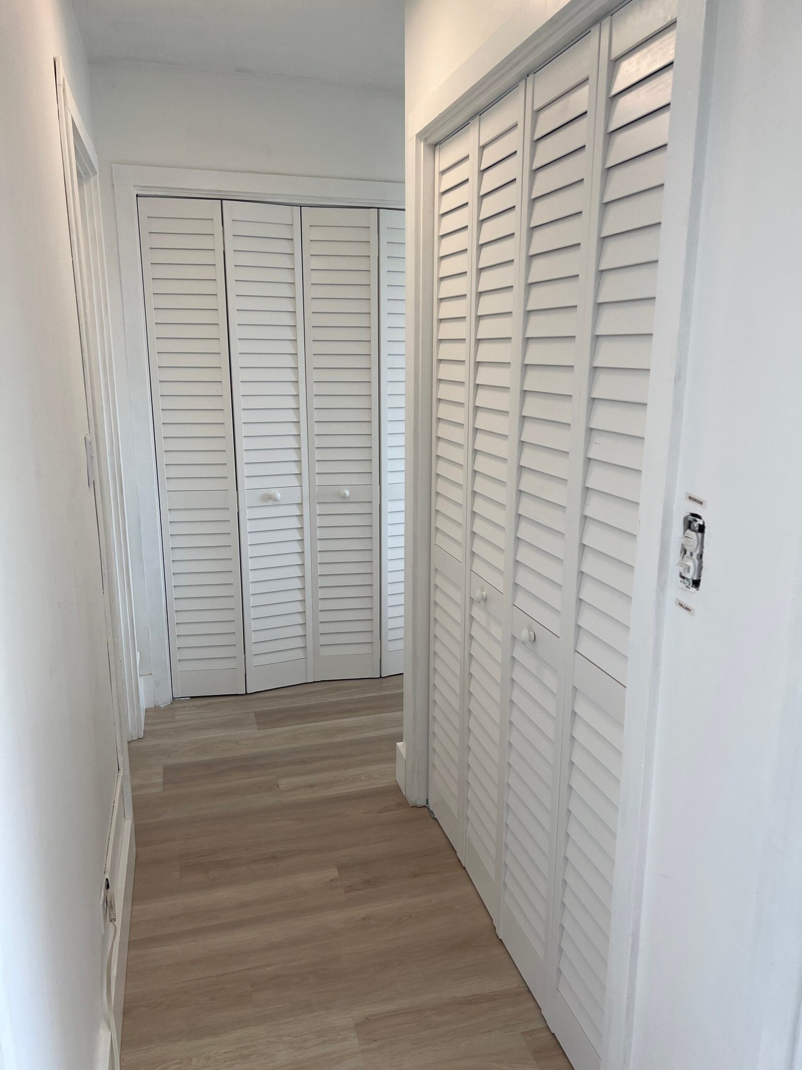 White louvre doors tidy up the hallway considerably